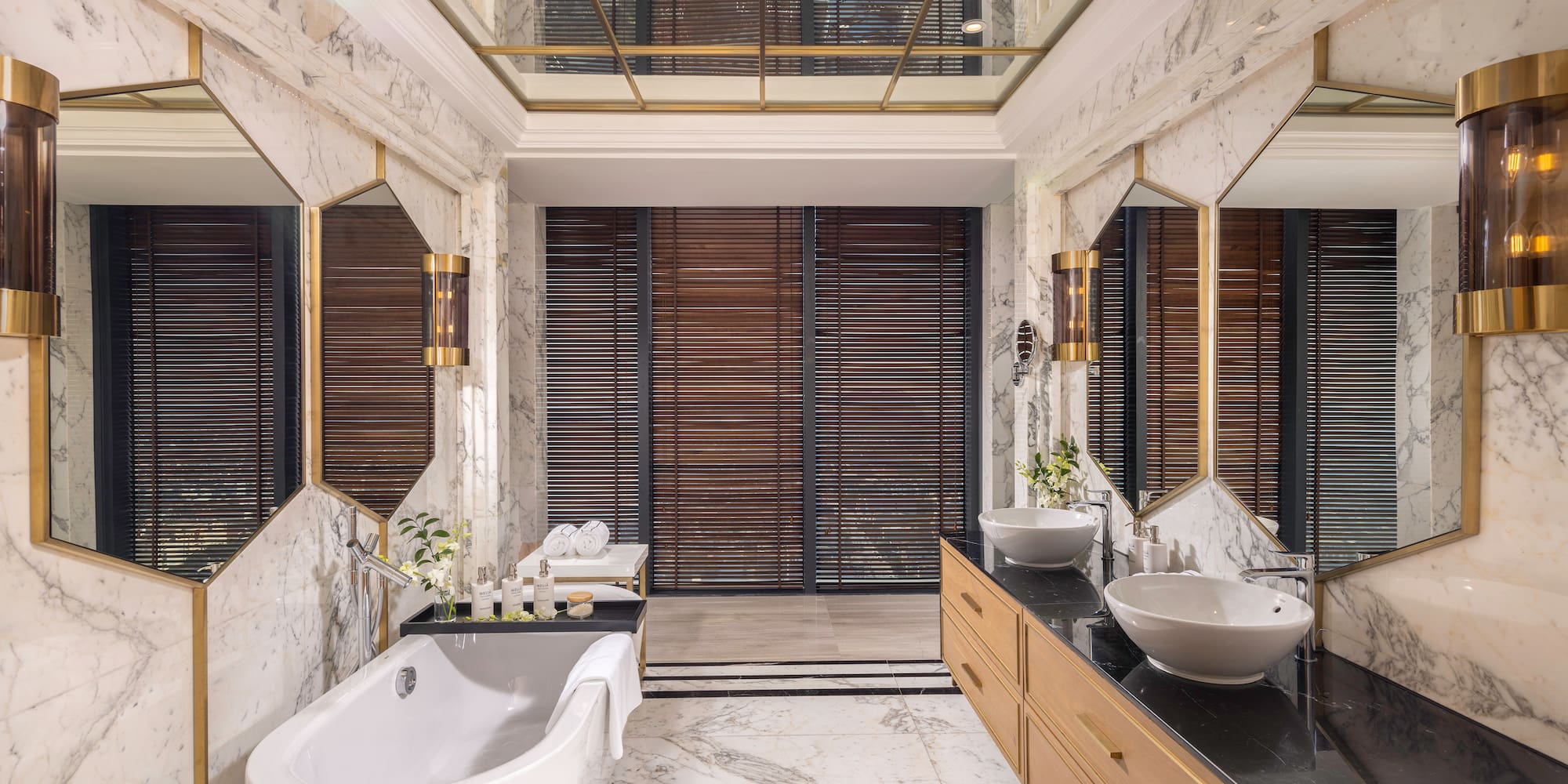 a bathroom with marble walls and a tub