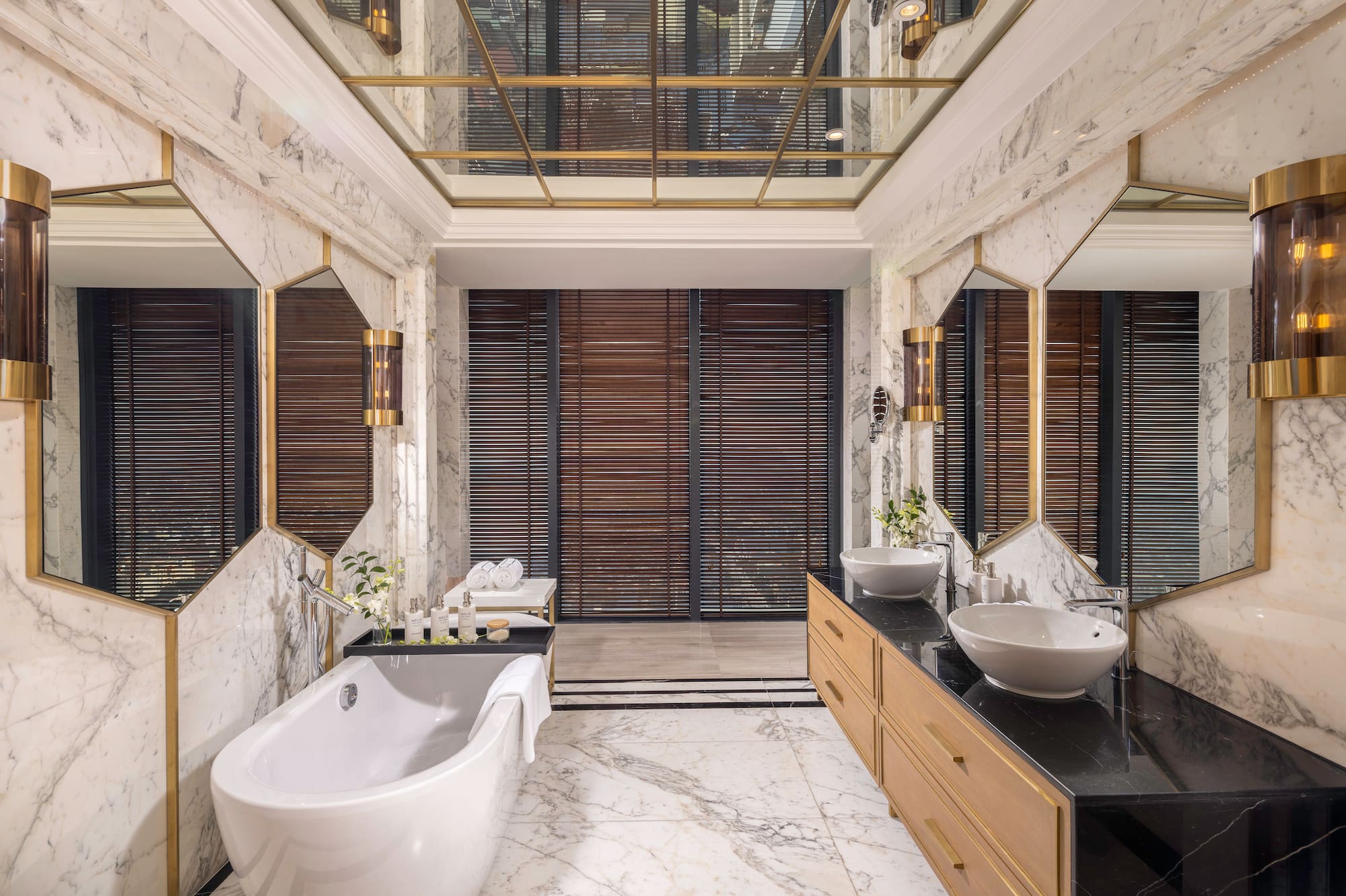a bathroom with marble walls and a tub