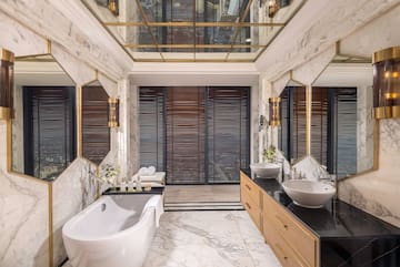 a bathroom with marble walls and a tub