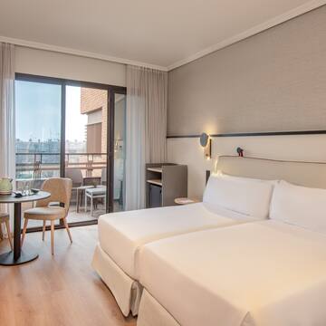 a room with two beds and a table