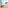 Woman in bed, family on balcony overlooking beach and palm trees.
