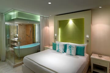 a bedroom with a bathtub and a bed
