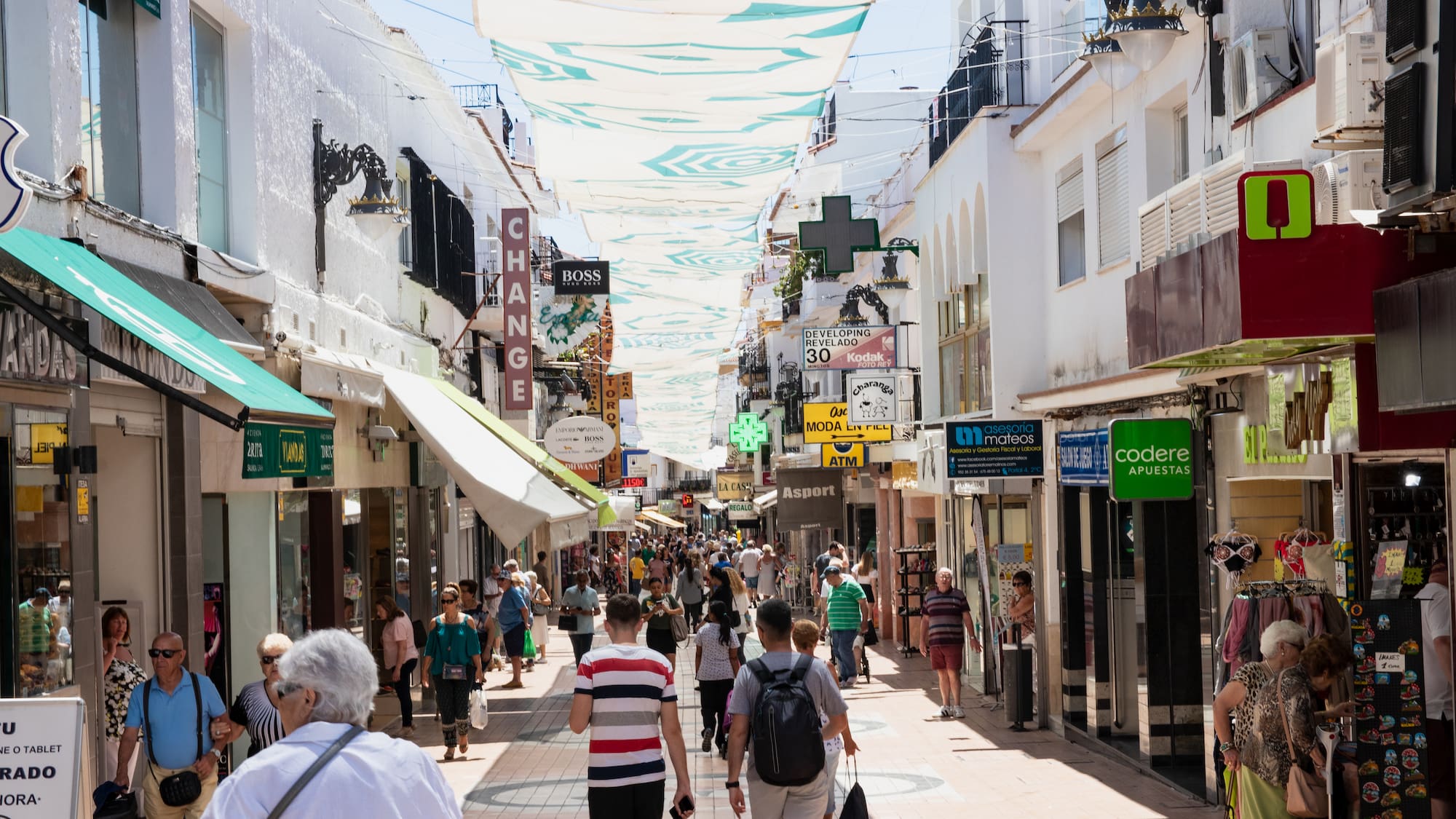 a group of people walking down a street