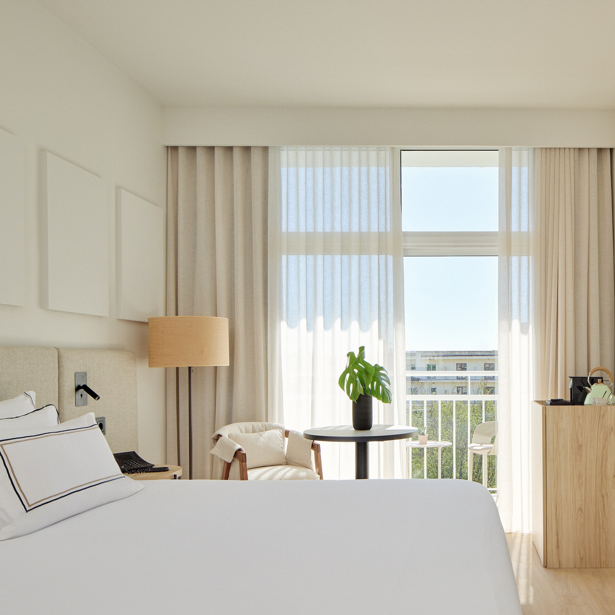 a bedroom with a bed and a table and chairs