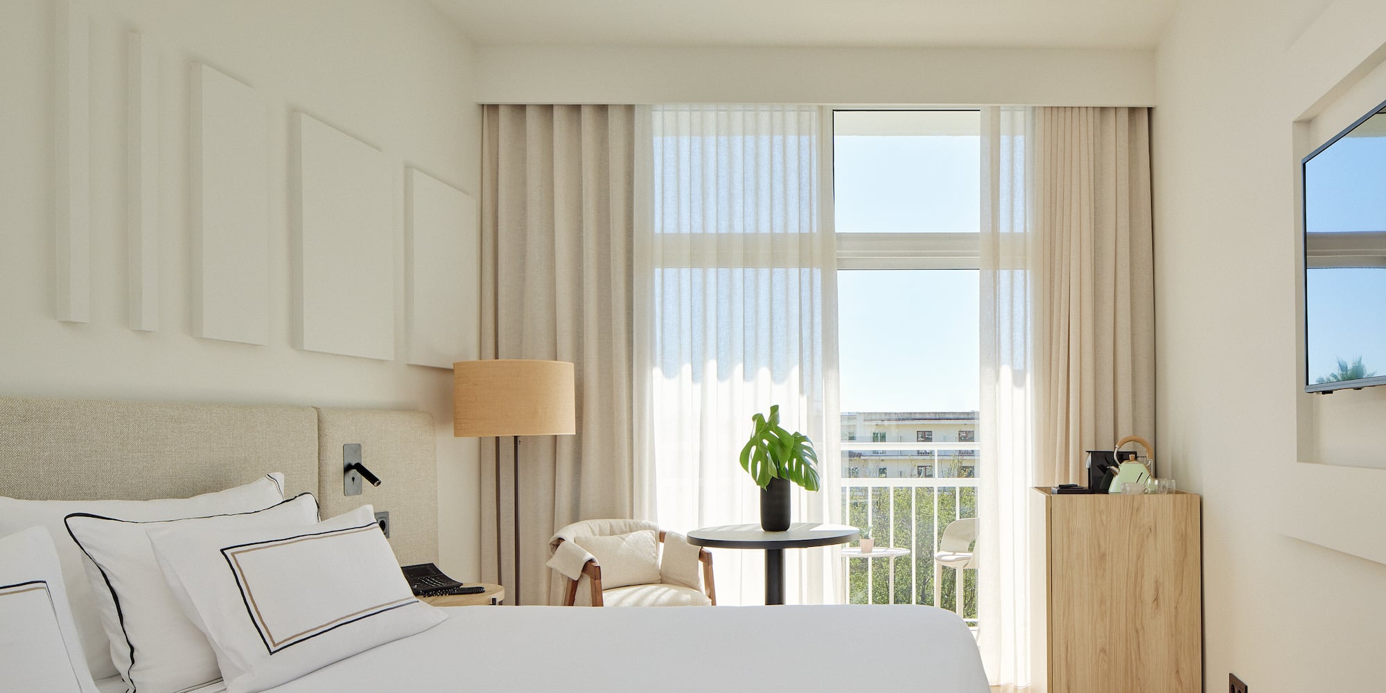 a bedroom with a bed and a table and chairs