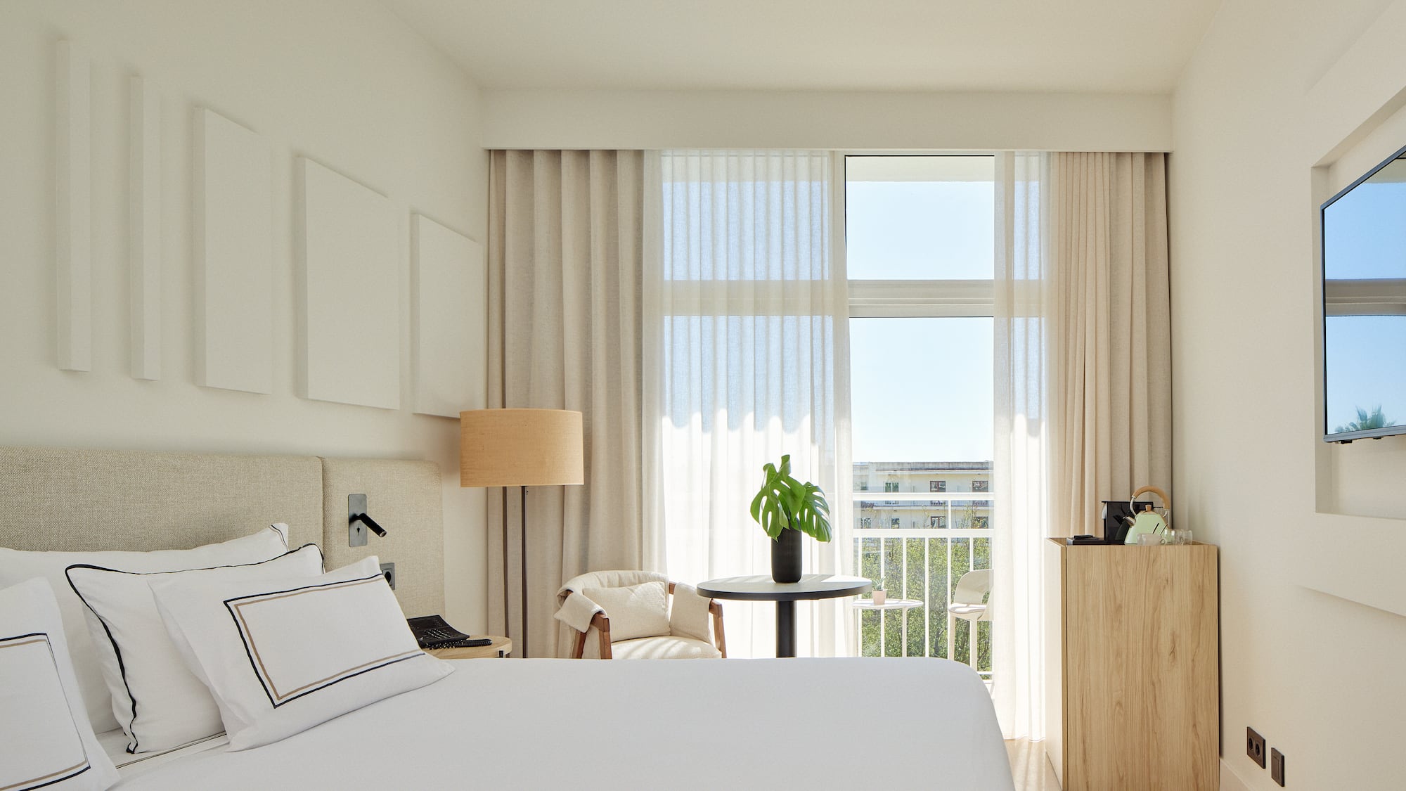 a bedroom with a bed and a table and chairs