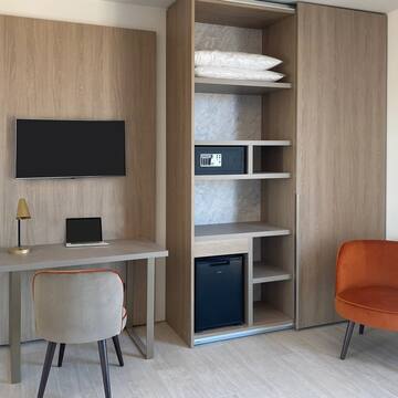 a room with a tv and a desk