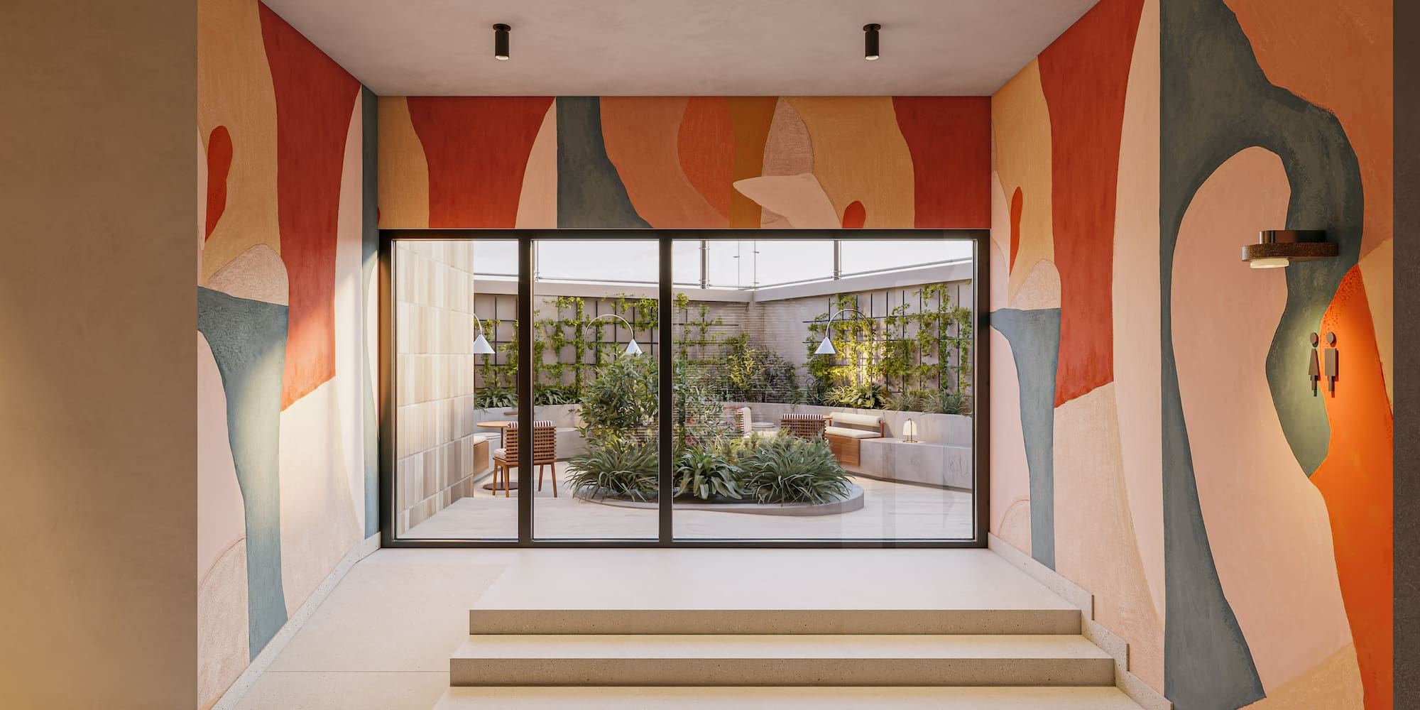 Colorful abstract mural hallway, steps, and view of a green courtyard.