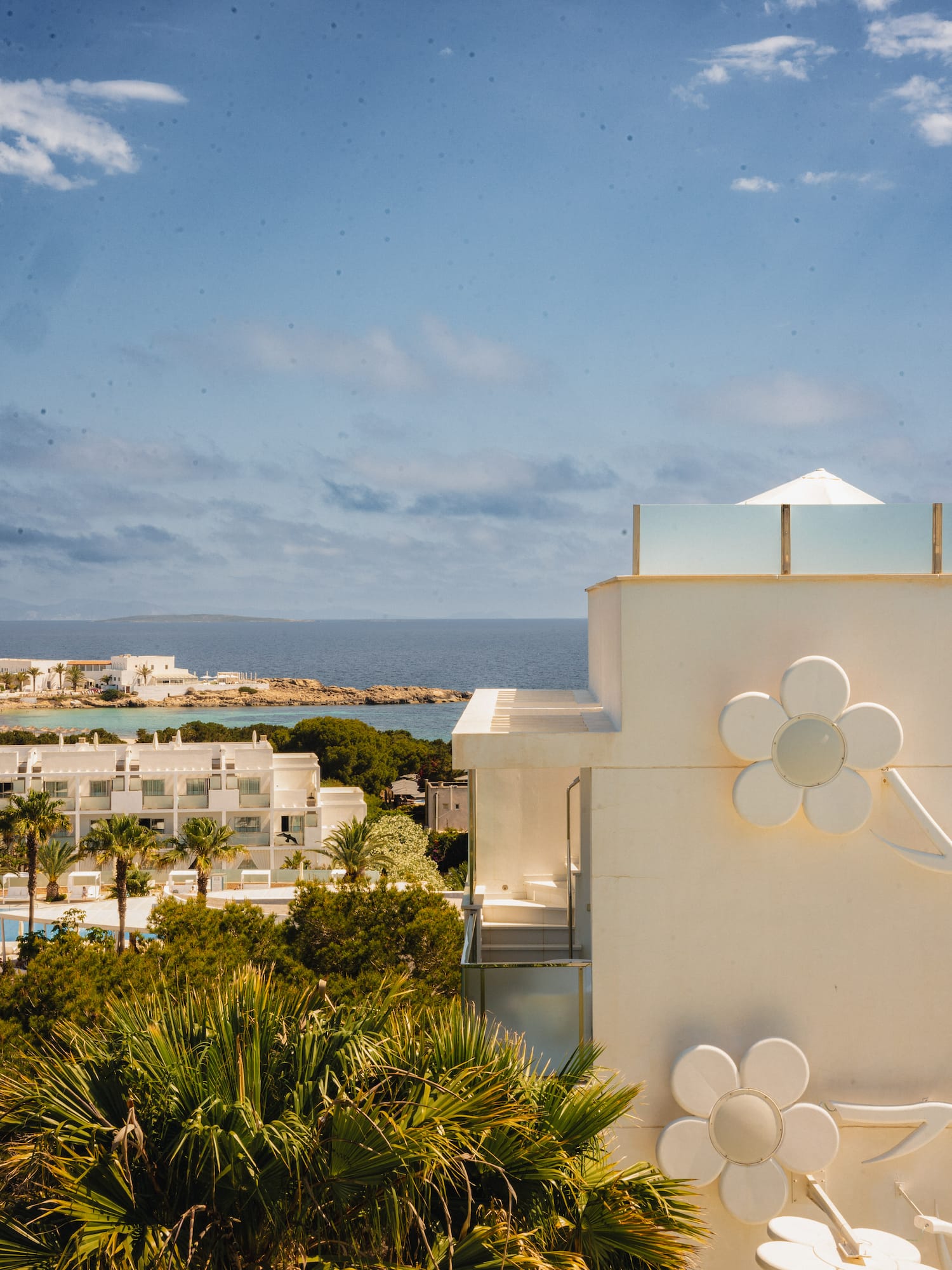 a white building with a flower on the side