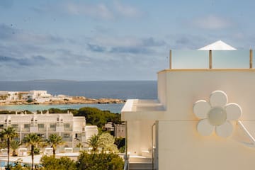 a white building with a flower on the side