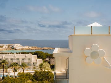 a white building with a flower on the side