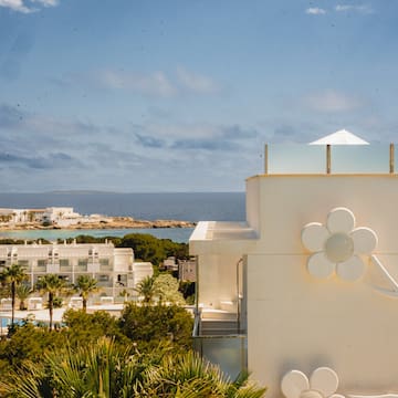 a white building with a flower on the side