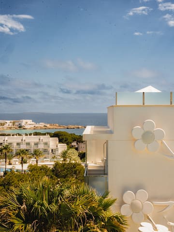 a white building with a flower on the side