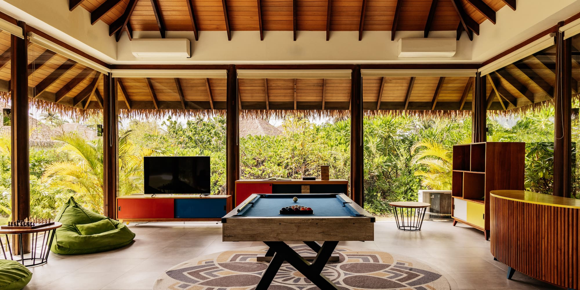 a pool table in a room with a television and a television