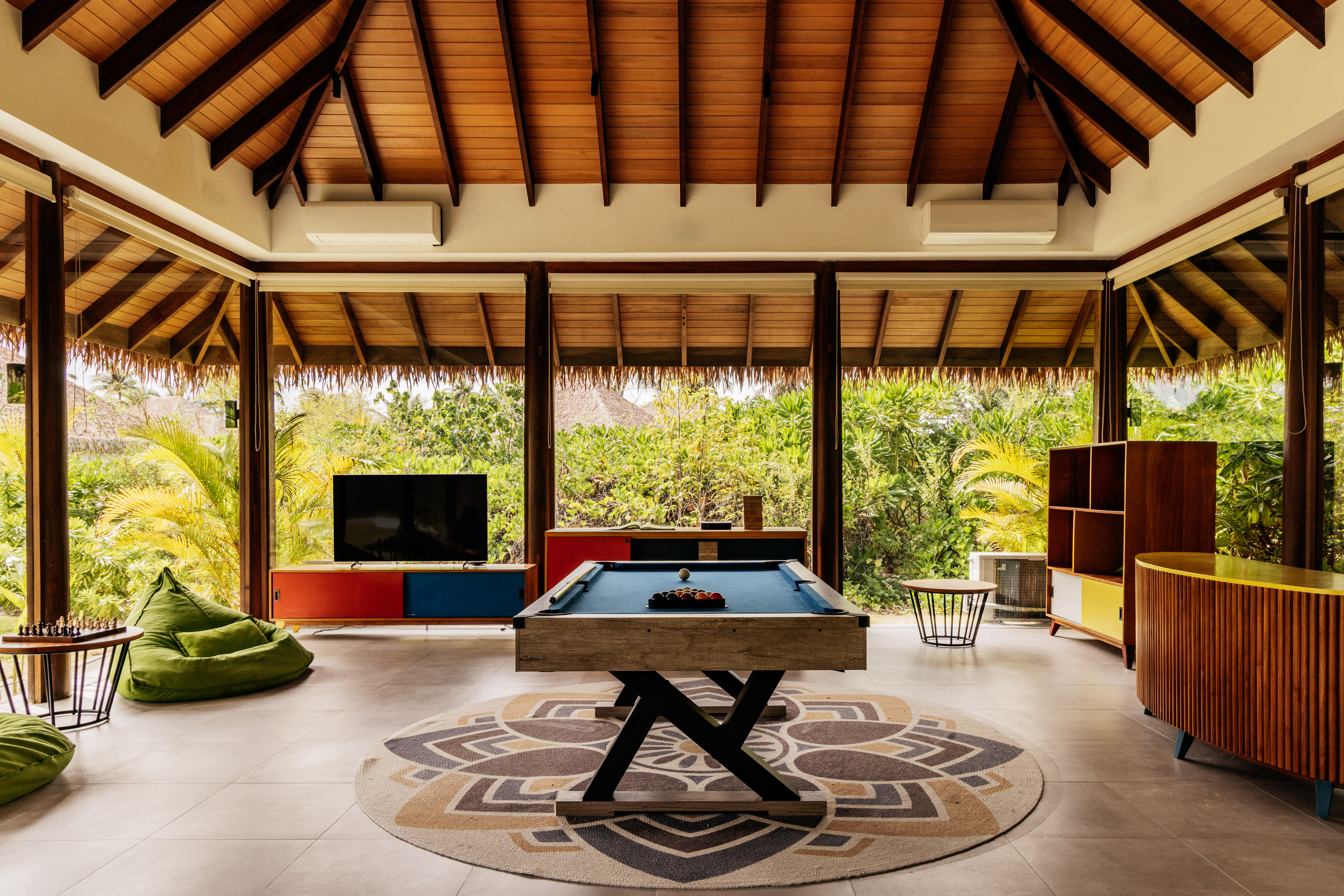 a pool table in a room with a television and a television