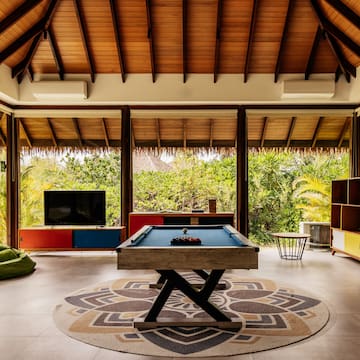 a pool table in a room with a television and a television