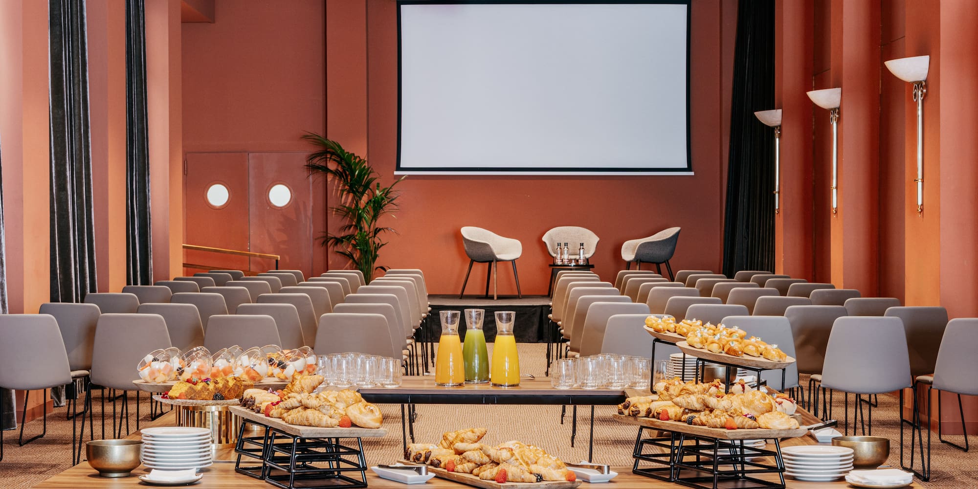 a room with a large screen and food on a table