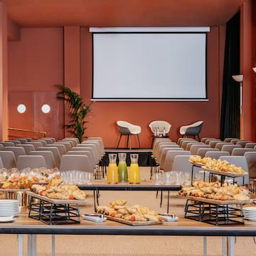 a room with a large screen and food on a table