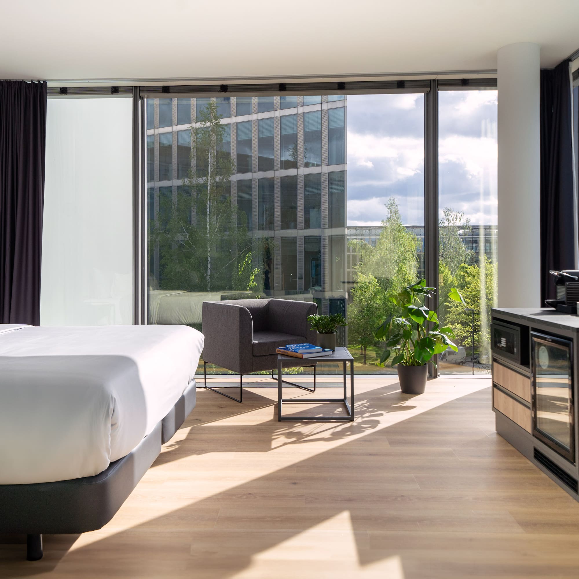 a room with a bed and a stove and a chair