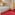 Hotel room with white bed, red carpet, mountain view window, and wardrobes.