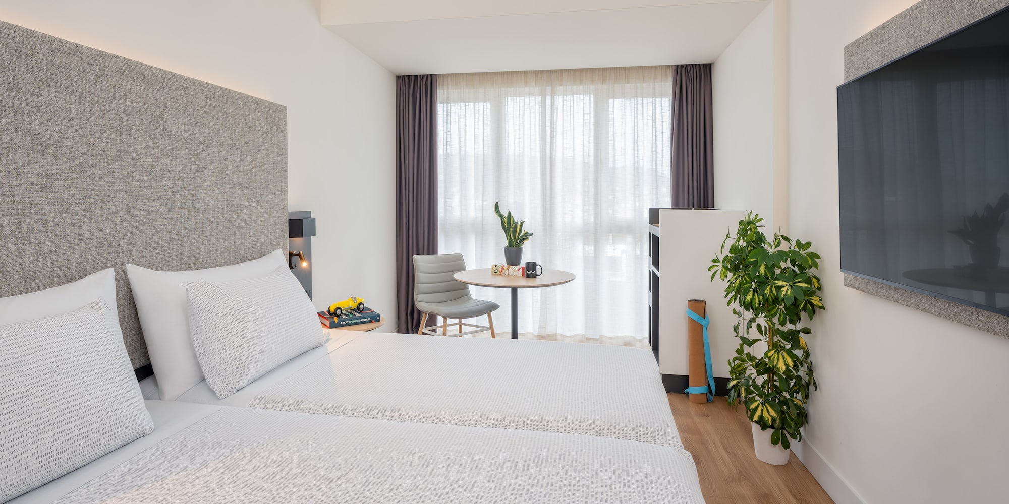 a room with two beds and a table