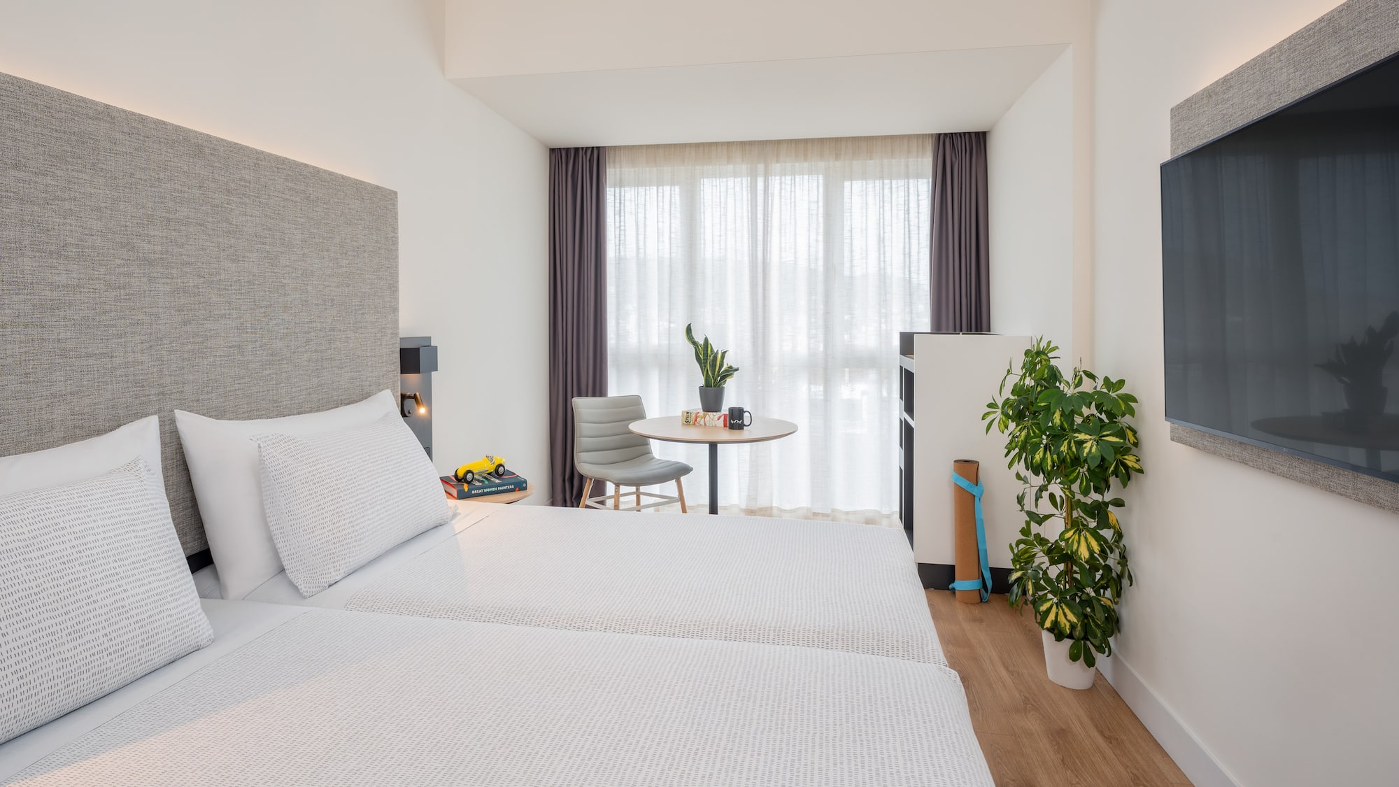 a room with two beds and a table