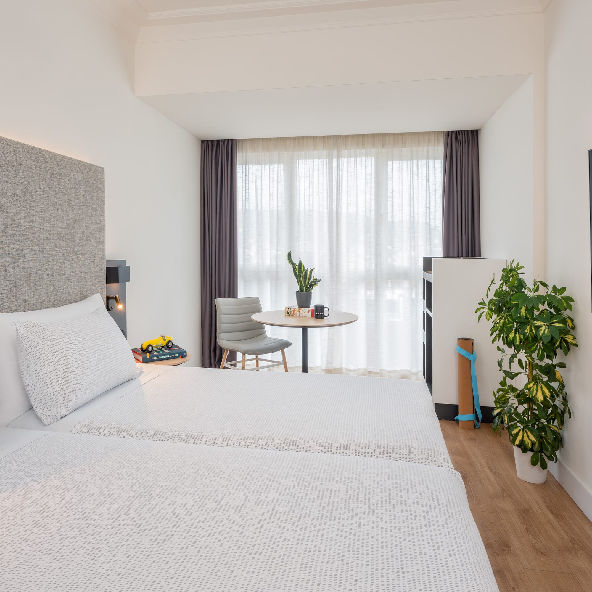 a room with two beds and a table