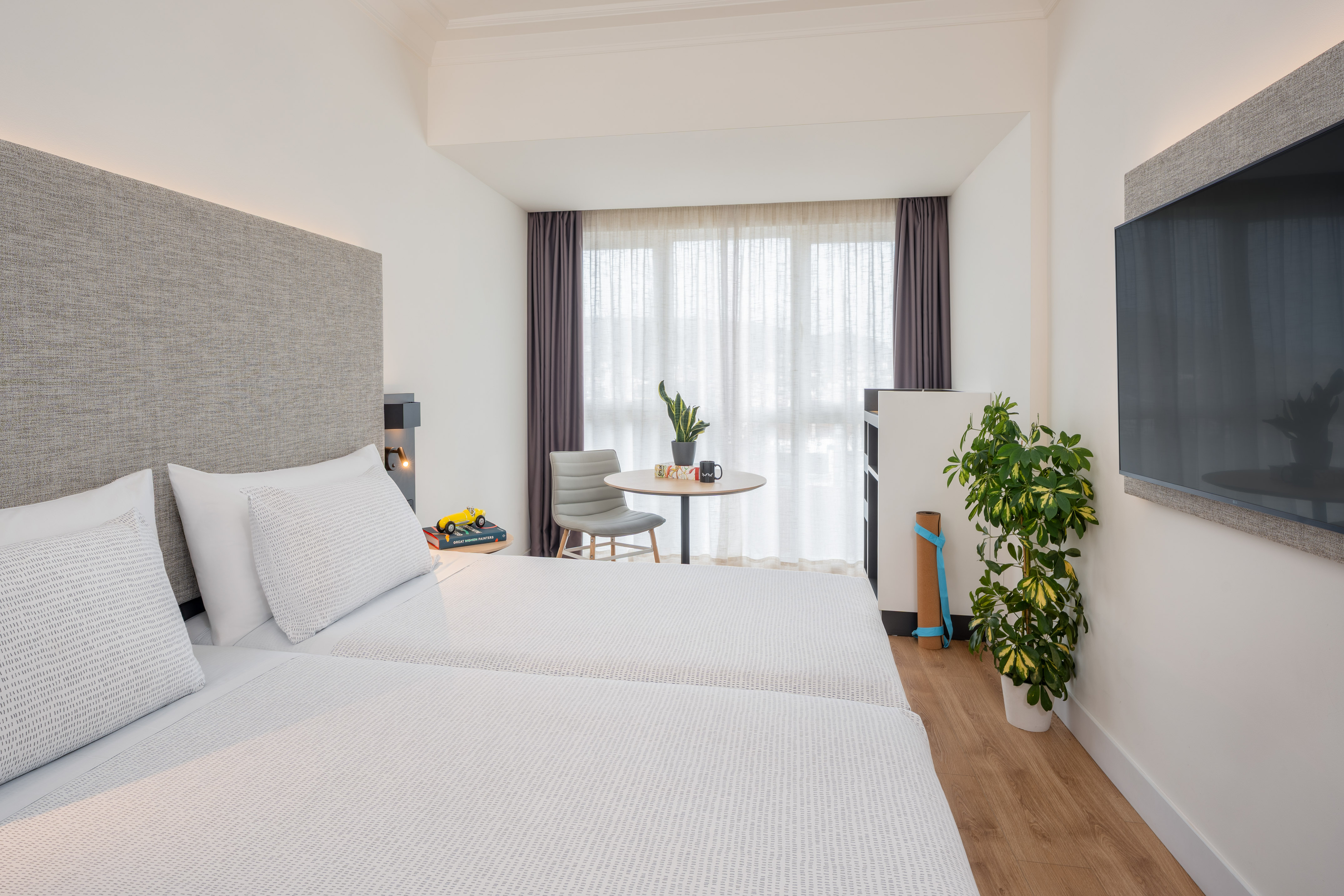 a room with two beds and a table