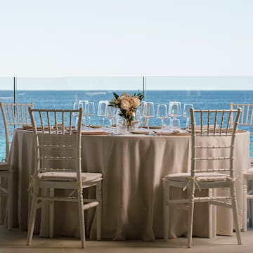 a table set up with chairs and a tablecloth