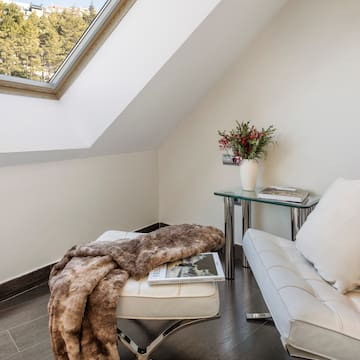 a white couch and a table in a room with a skylight