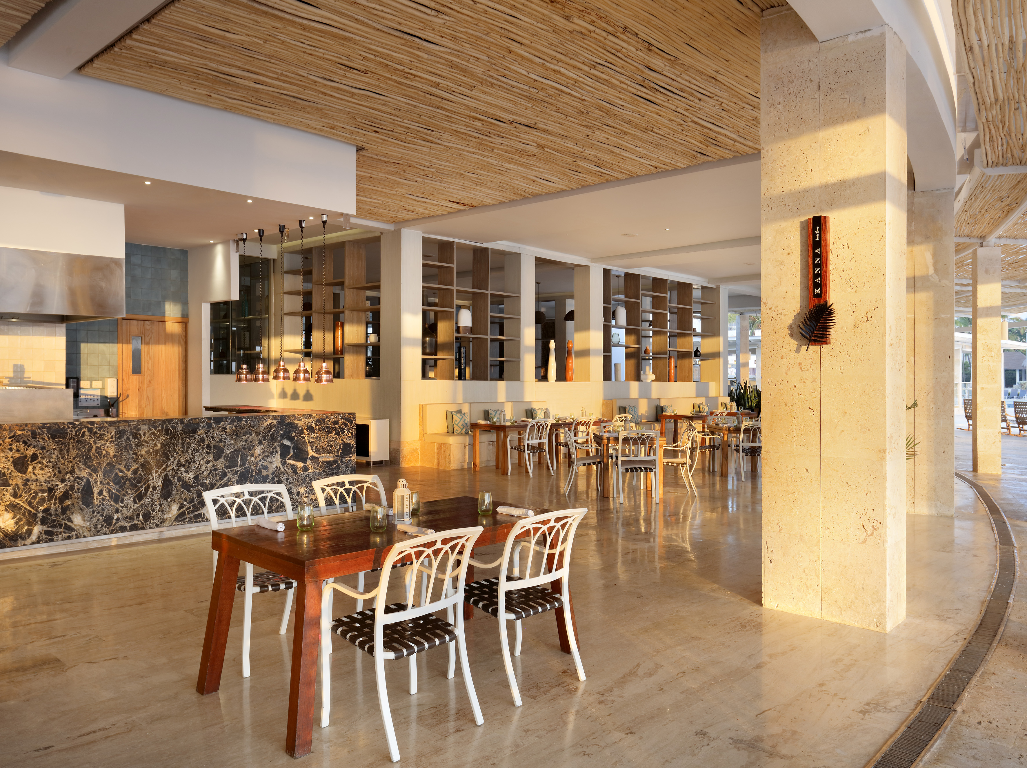 Kanna restaurant interior: modern dining, marble bar, wood-slat ceiling.