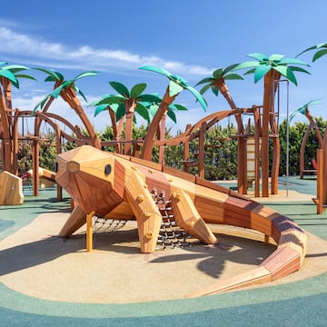a wooden lizard on a playground