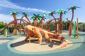 a wooden lizard on a playground