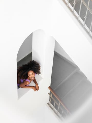 a woman leaning on a window ledge