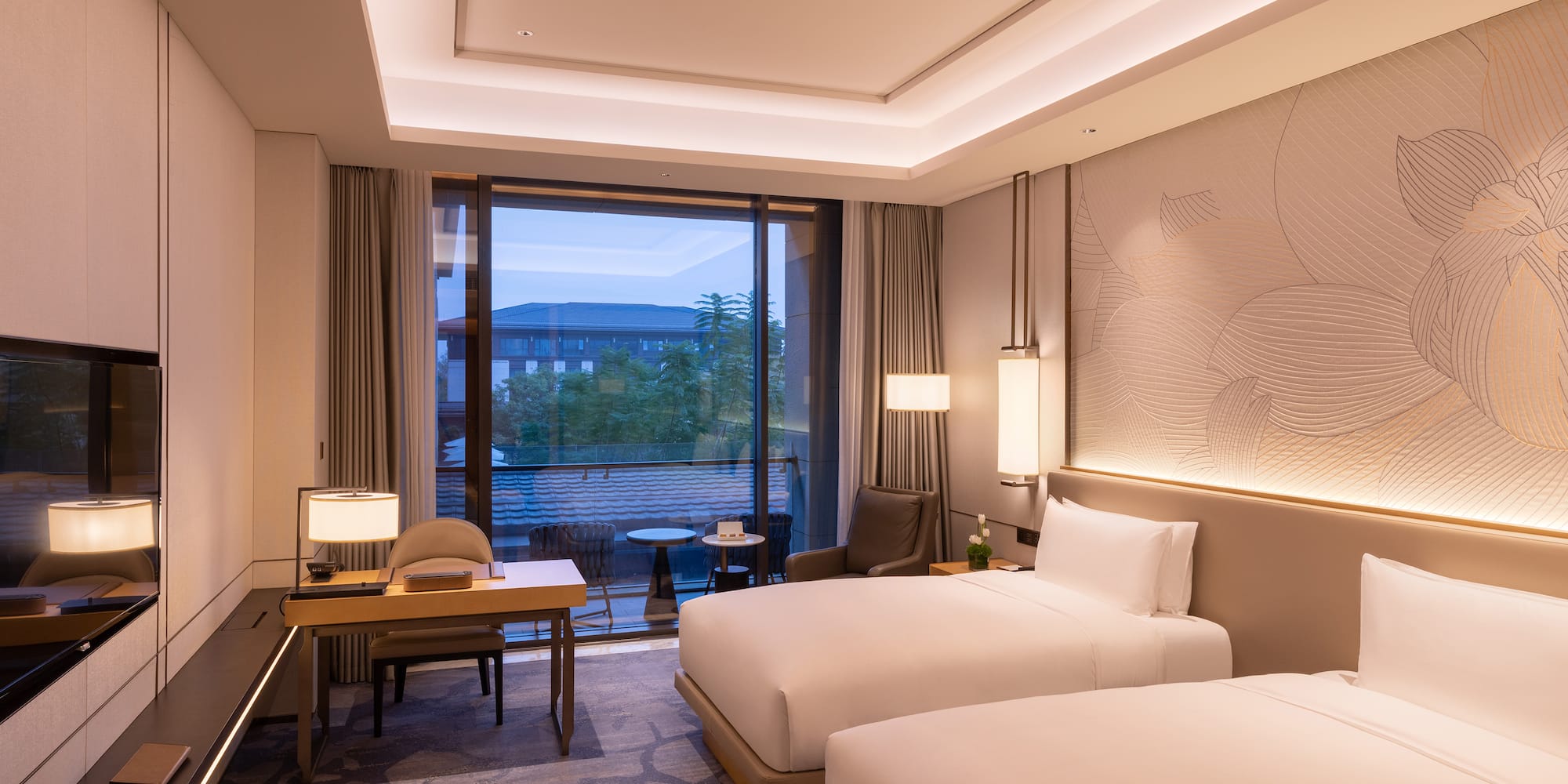 a room with two beds and a table