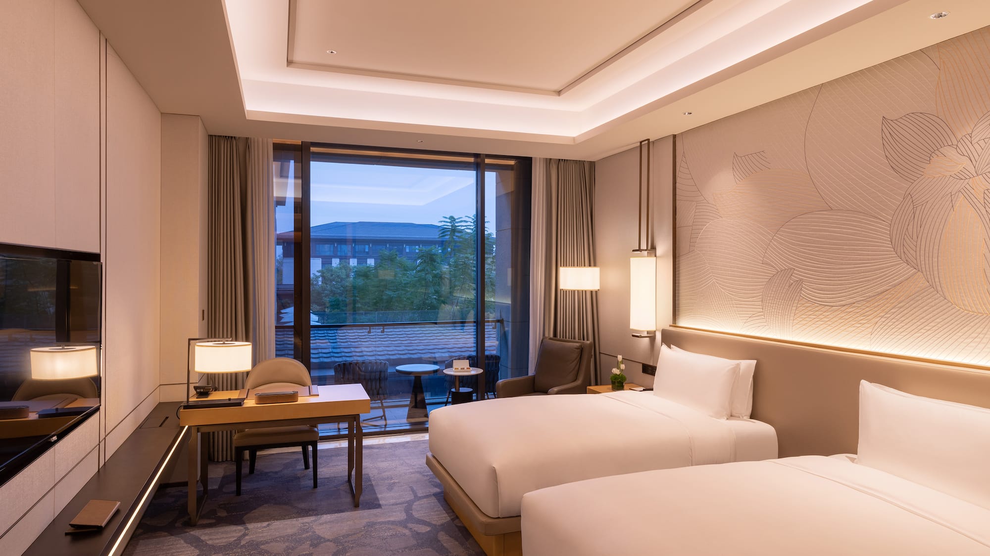 a room with two beds and a table