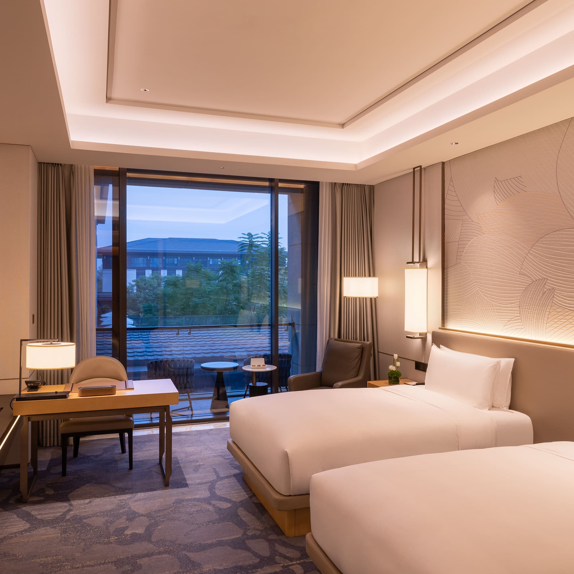 a room with two beds and a table