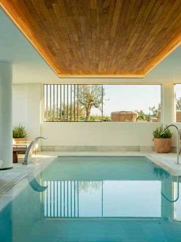 a indoor pool with a wooden ceiling