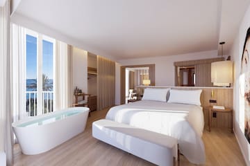 a bedroom with a bathtub and a bed