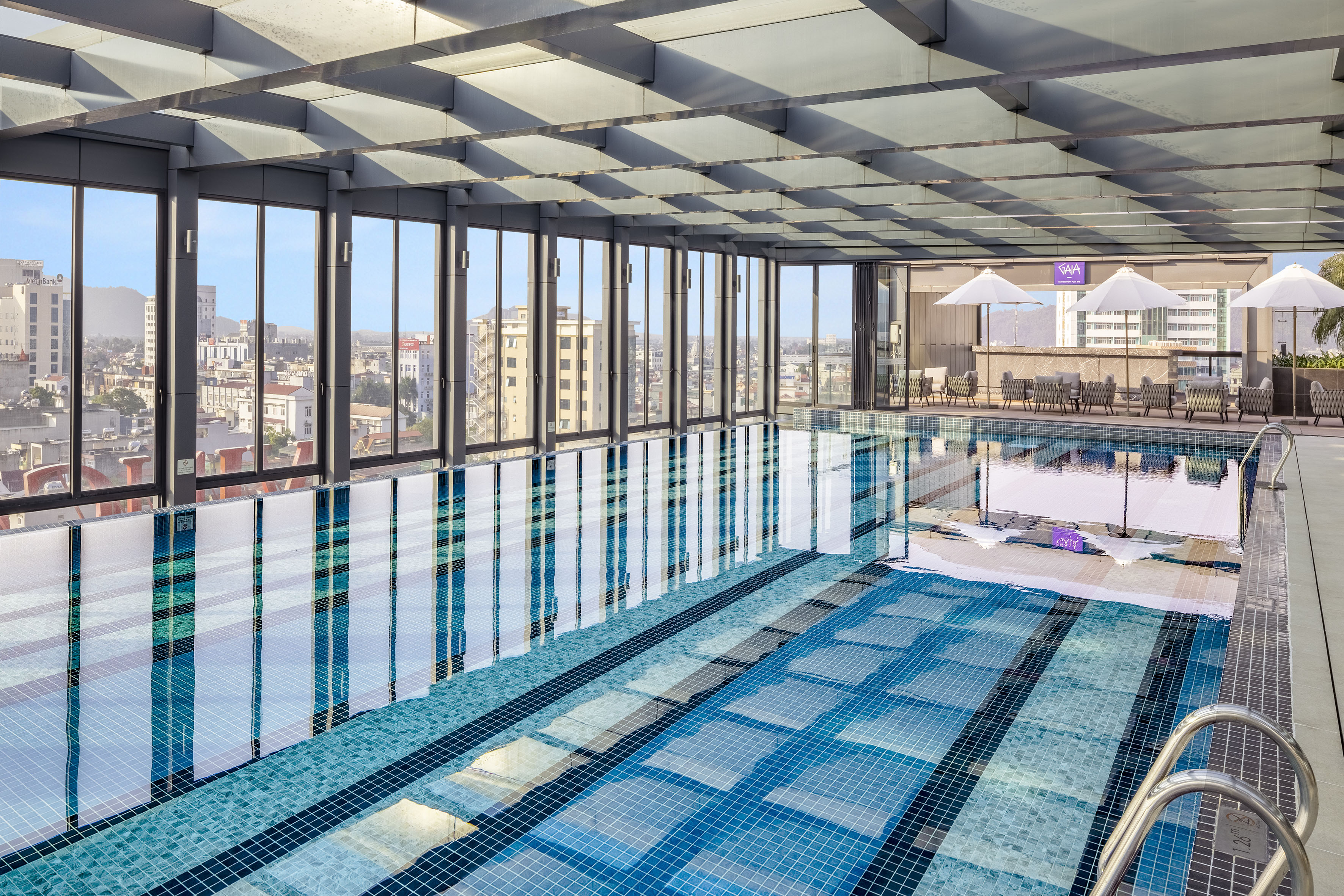 a swimming pool with a large glass wall