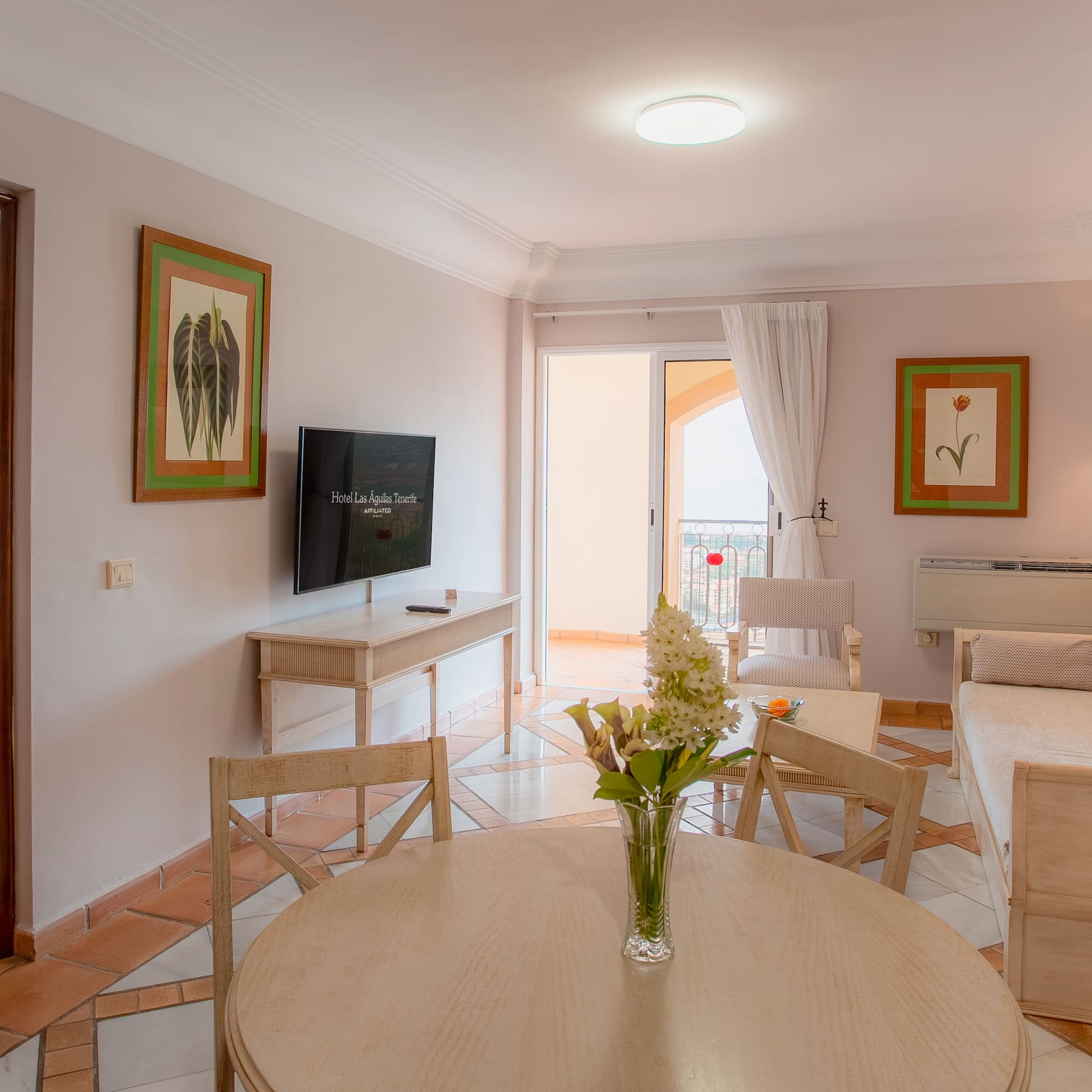 a living room with a television and a table