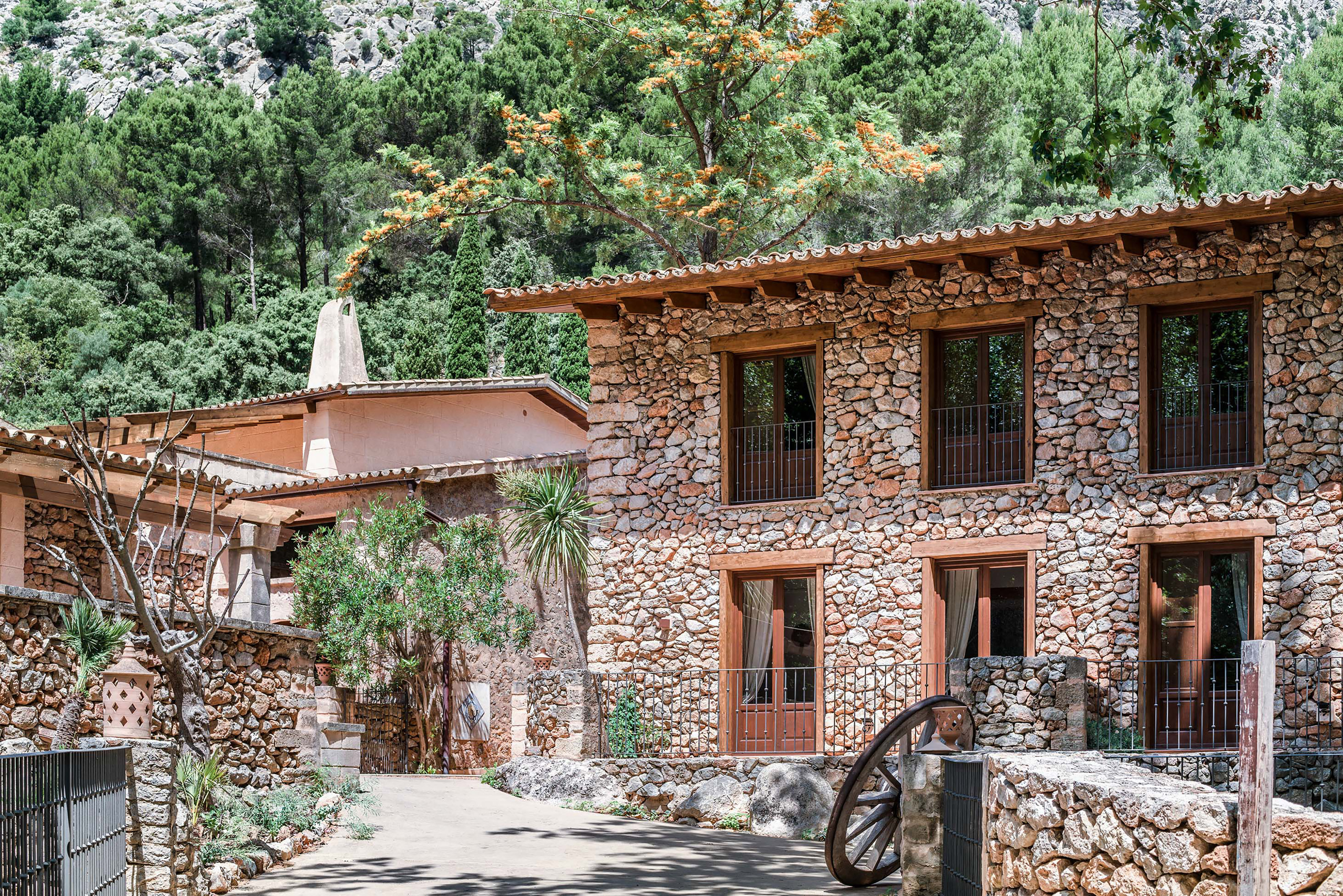 a stone building with a wheel in front of it