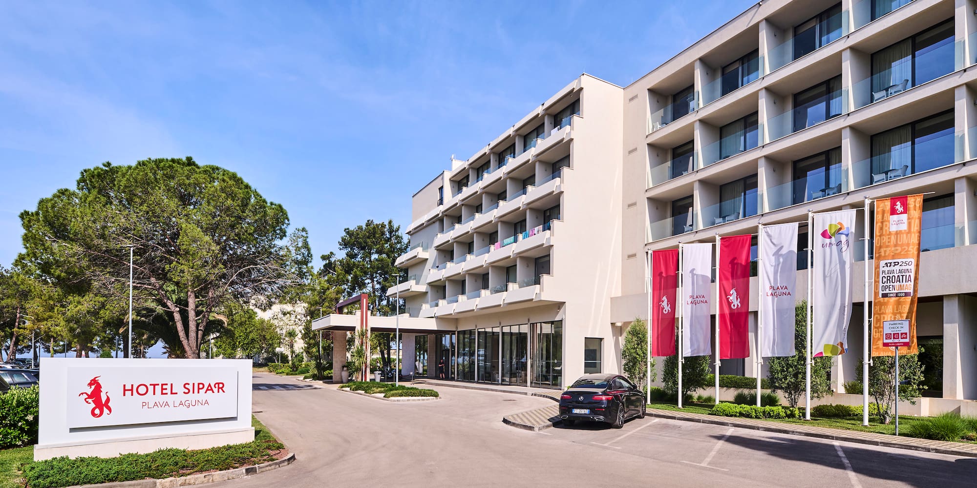a building with a parking lot and a car