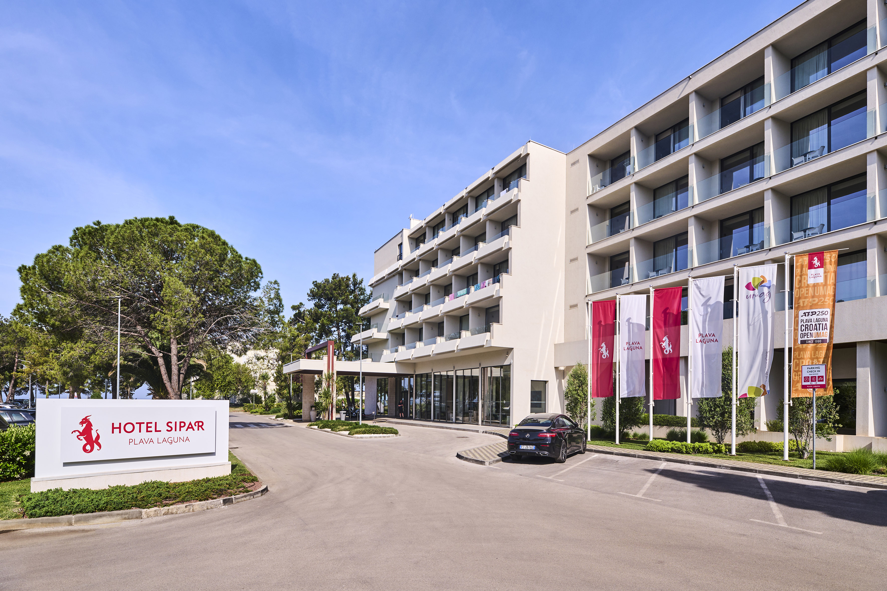 a building with a parking lot and a car