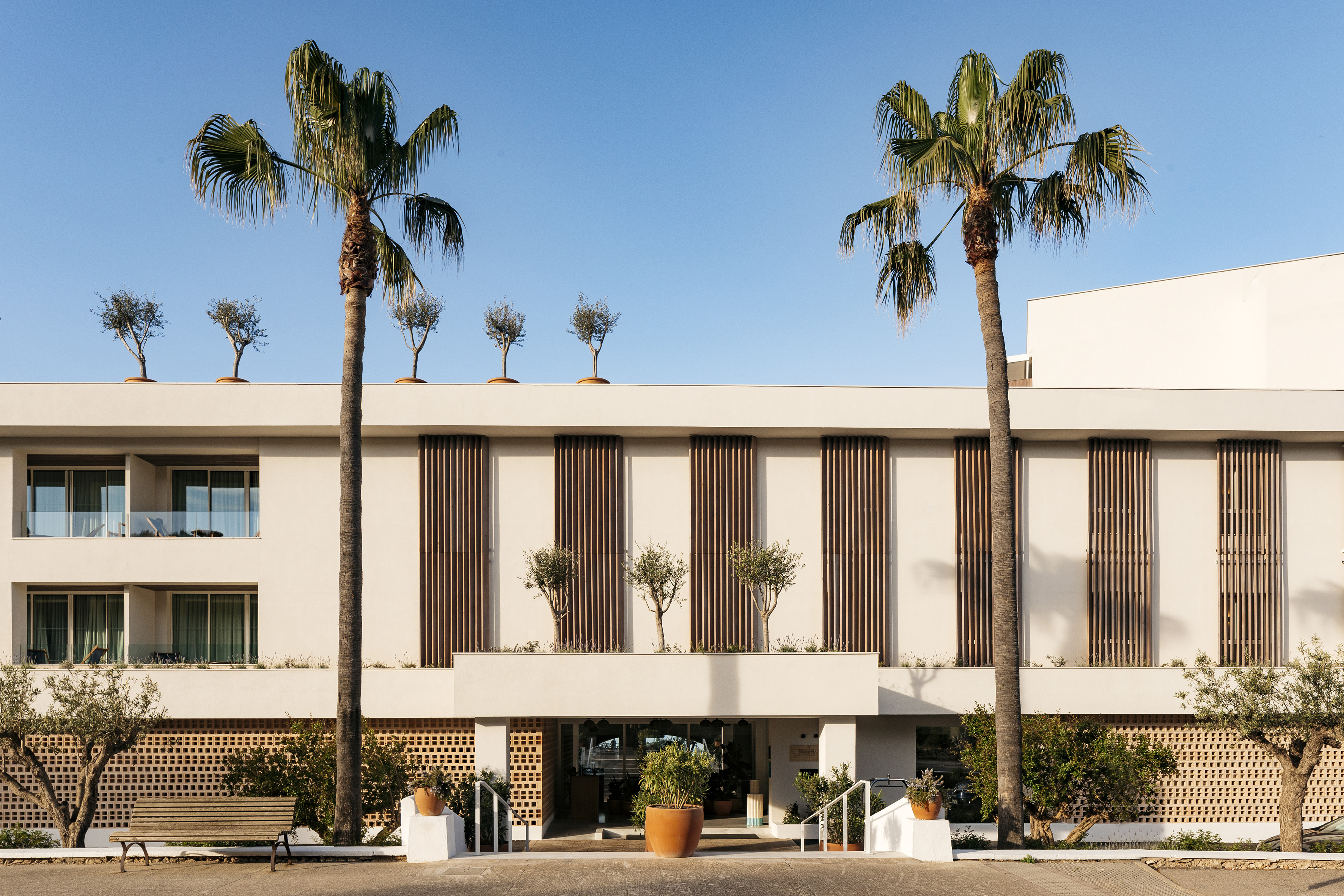 a building with palm trees and plants