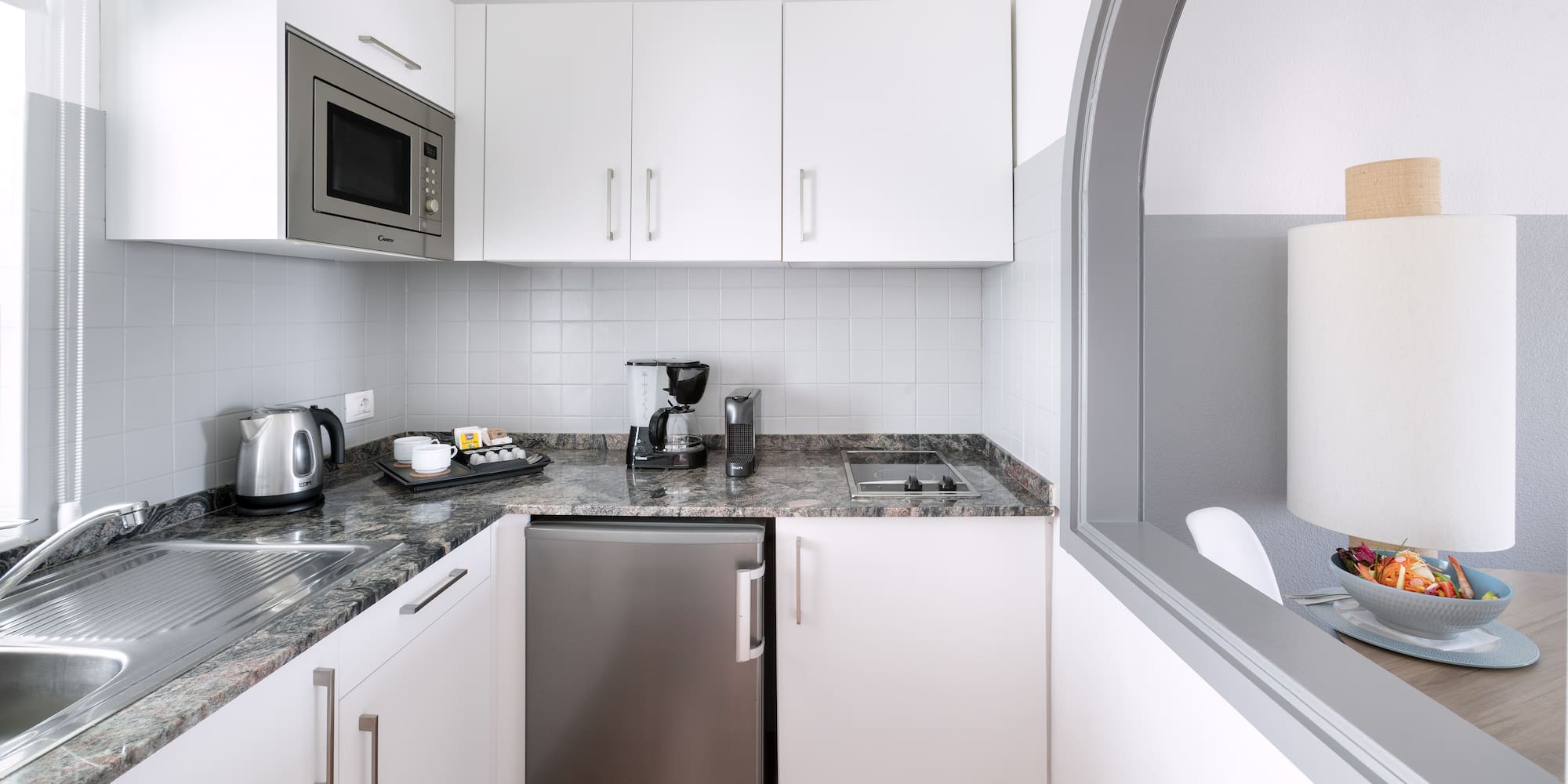 a kitchen with a microwave and a refrigerator