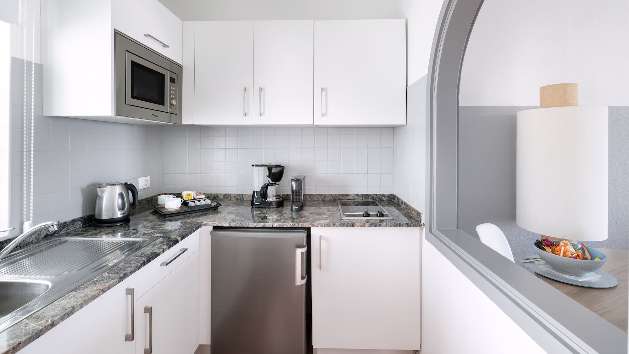 a kitchen with a microwave and a refrigerator