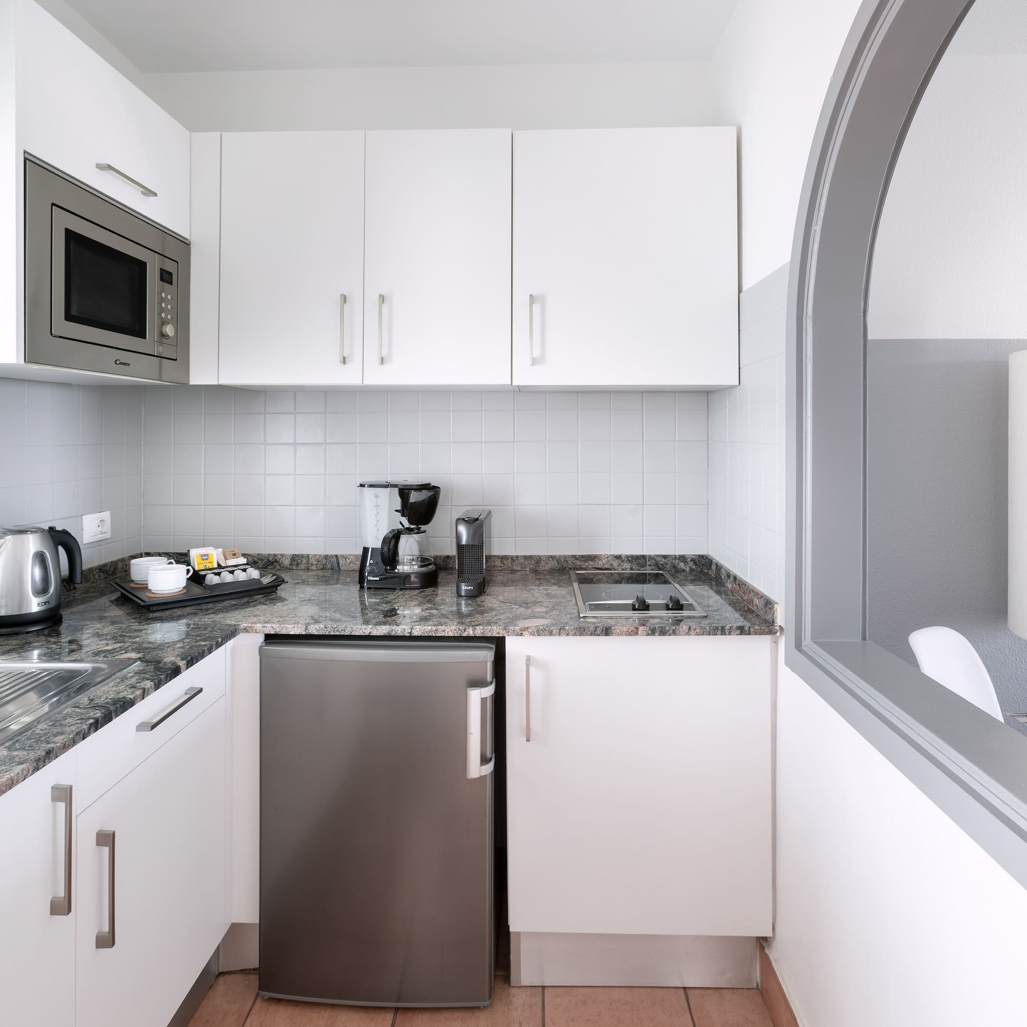 a kitchen with a microwave and a refrigerator