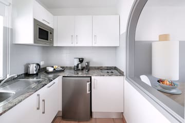 a kitchen with a microwave and a refrigerator