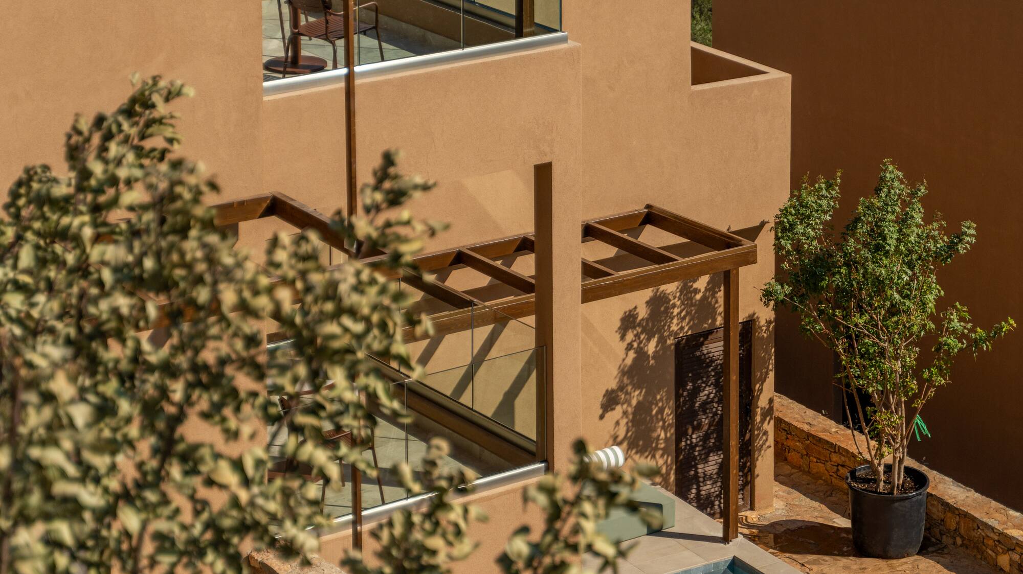 a building with a pool and a tree